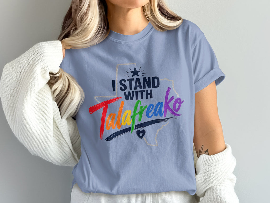 Light blue t-shirt with "I STAND WITH Talafreako" in rainbow and black text.