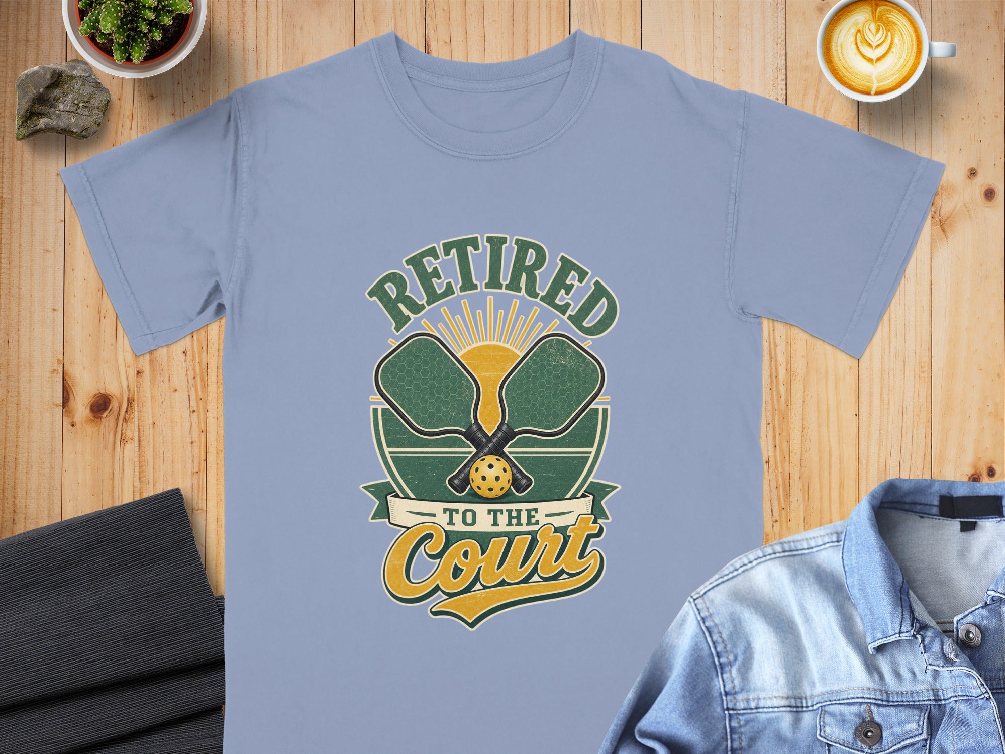 Light blue t-shirt with "Retired to the Court" graphic featuring pickleball paddles and ball.
