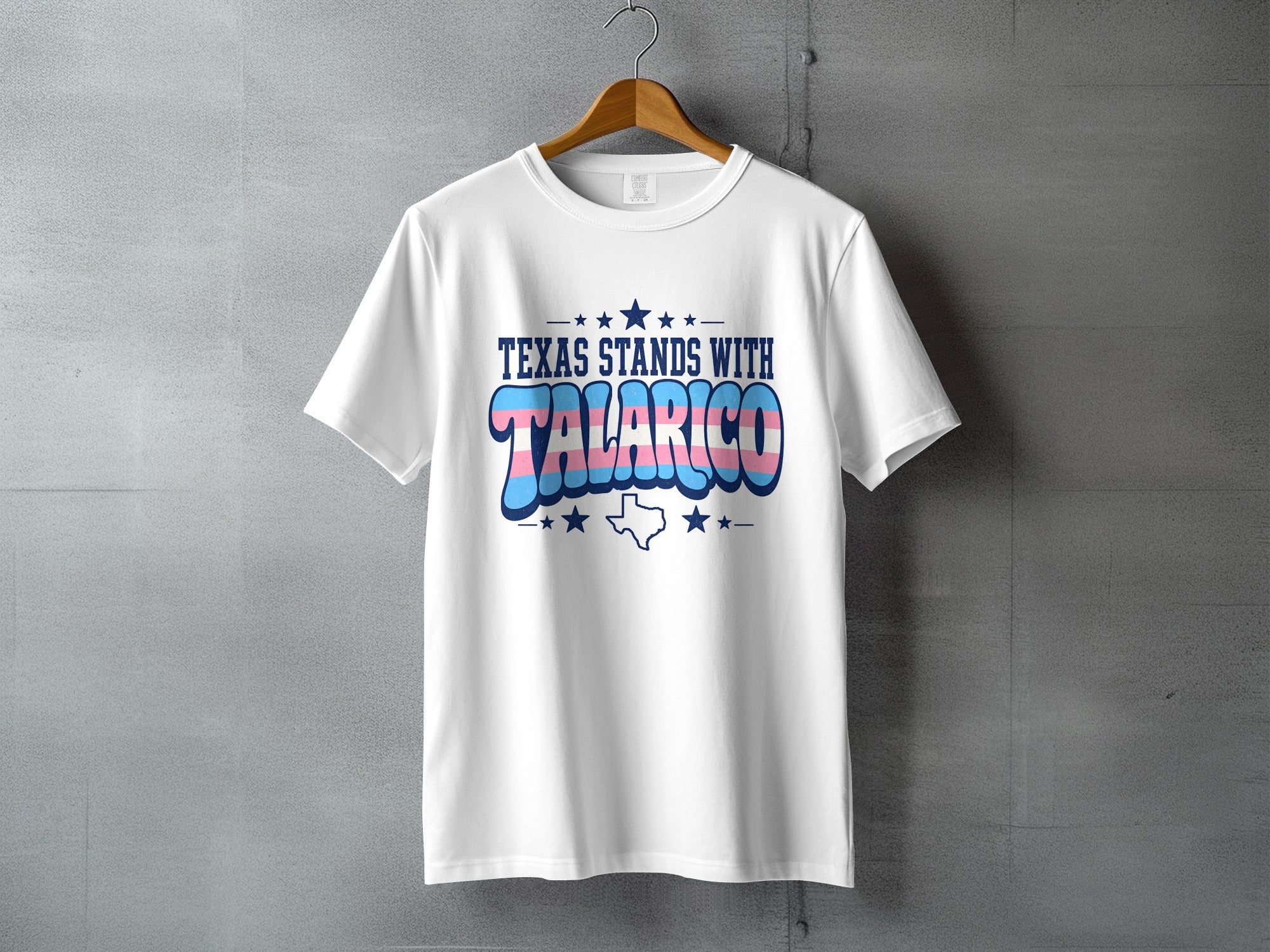 White t-shirt with "Texas Stands With Trans Rights" text and Texas flag stars.