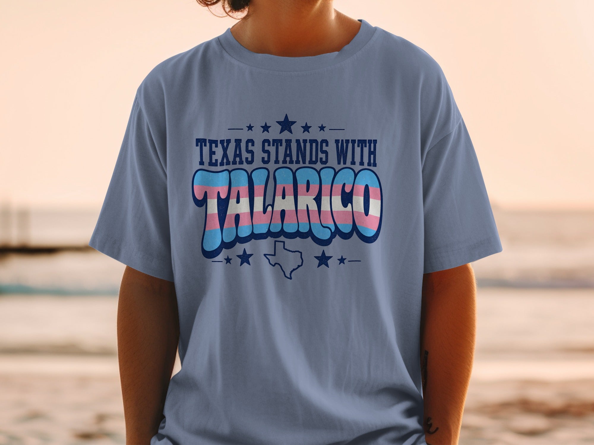Blue t-shirt with "Texas Stands With Talarico" and transgender flag colors.