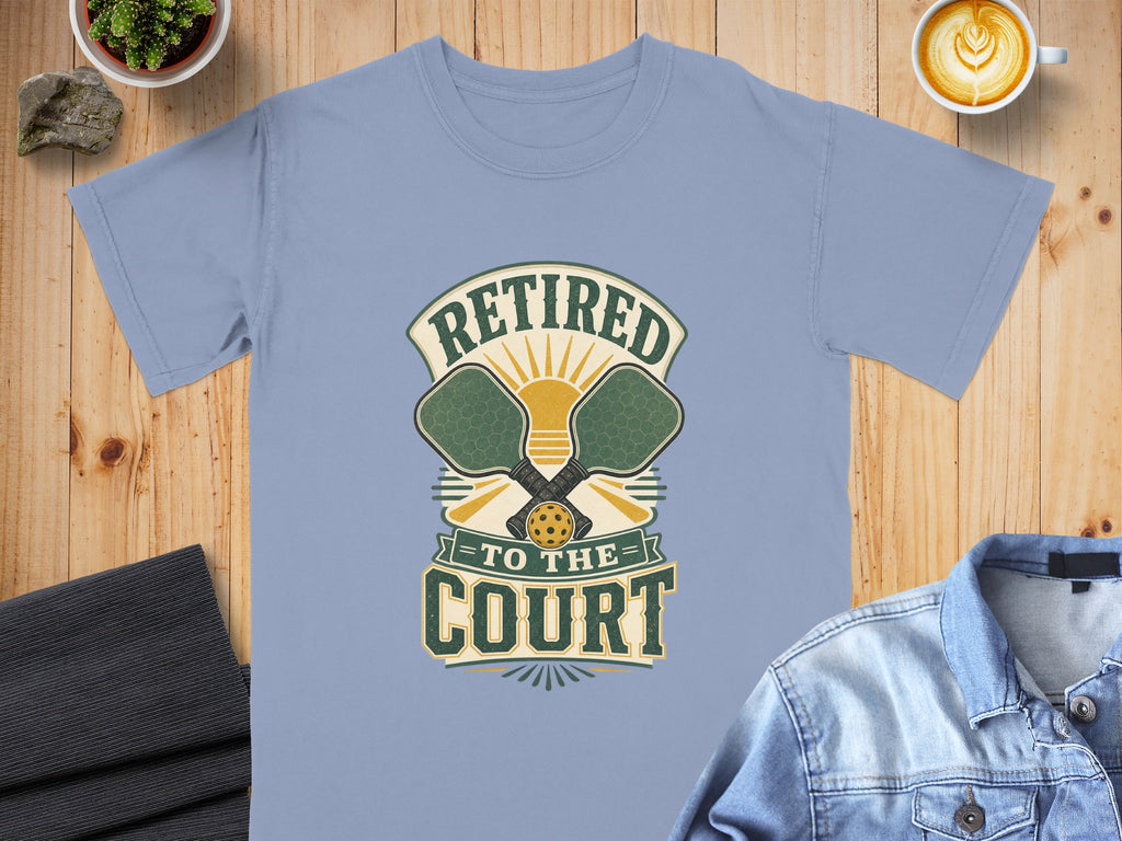 Light blue t-shirt with "Retired to the Court" pickleball graphic.