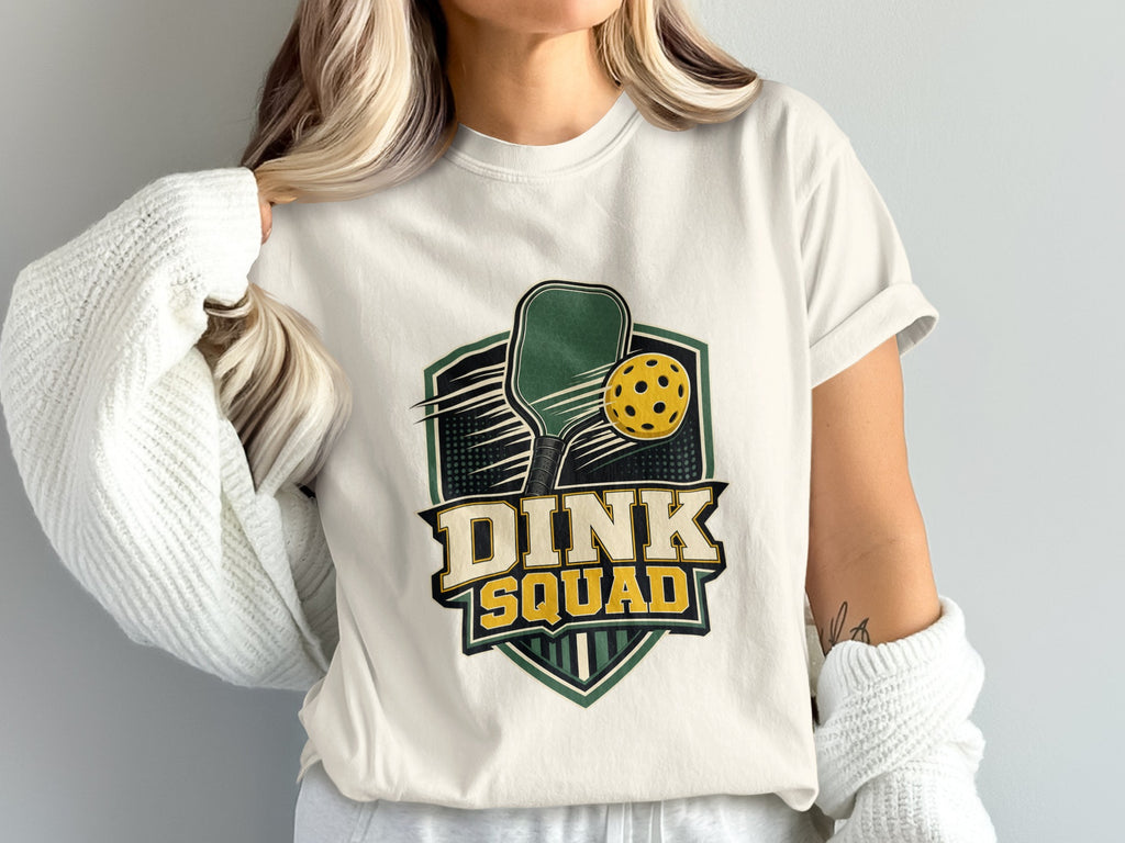 White t-shirt with "DINK SQUAD" graphic featuring pickleball paddle and ball.