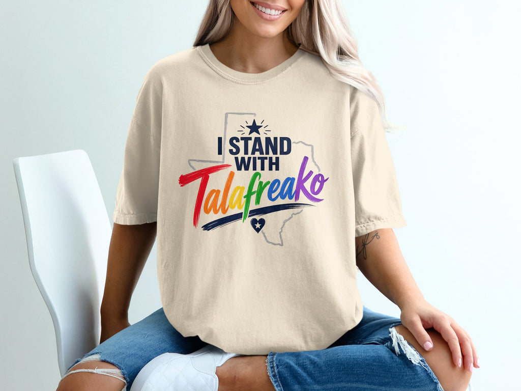 Cream t-shirt with "I STAND with TALAfreako" in colorful text and a Texas outline.