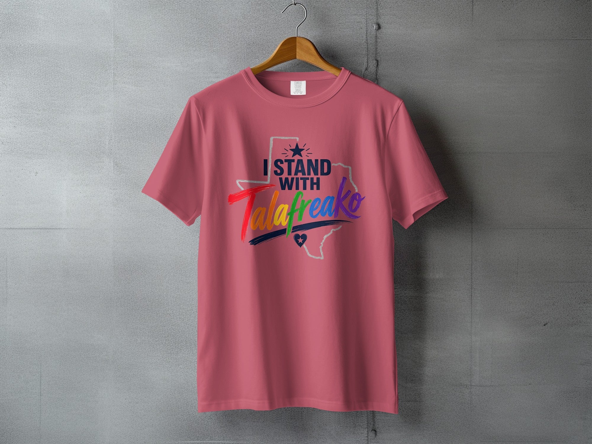 Pink t-shirt with "I STAND WITH TALAfreako" text and a Texas outline.