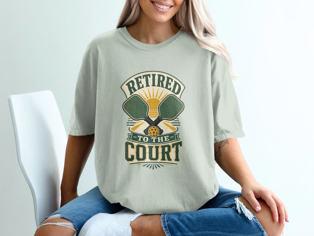 Pistachio t-shirt with "Retired To The Court" pickleball graphic.